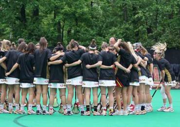 girls field hockey team in a huddle