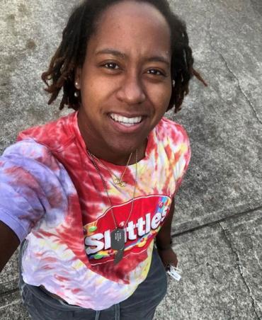 Brittany wearing a tie-dye skittles shirt