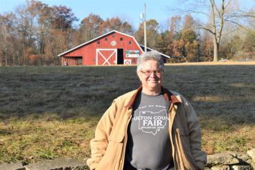 Beth standing in front of a red barn