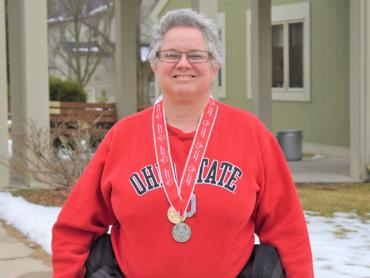 Beth wearing an Ohio State sweater and her Ski Medals