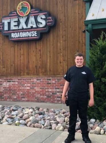 Blake outside Texas Roadhouse for his first summer job