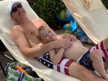 Charlie and his dad wearing American flag swim trunks