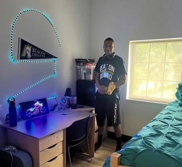 DJ hanging lights in his new dorm room