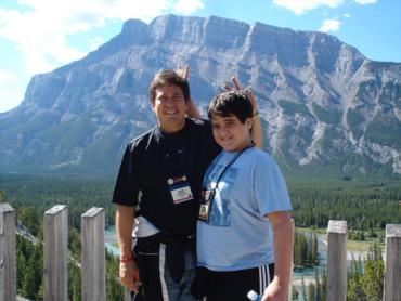 Dylan and his dad in front of a mountain