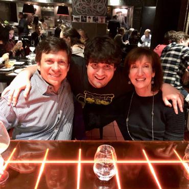 Dylan and his parents at a restaurant