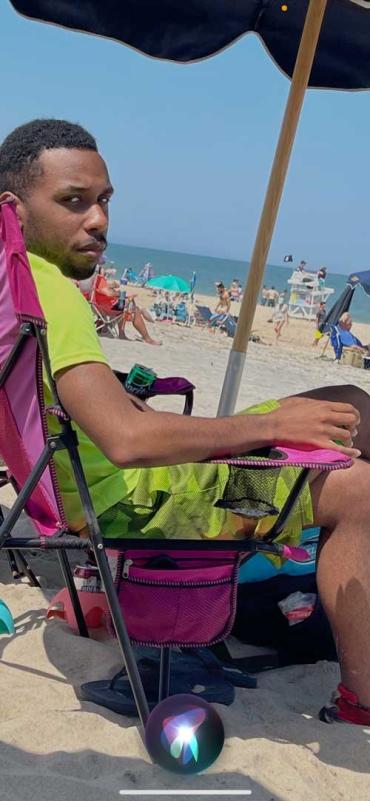 Ira sitting in a chair on the beach