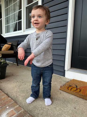 Jack standing on front porch wearing a grey shirt