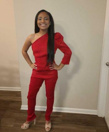 Jada wearing a red jumpsuit