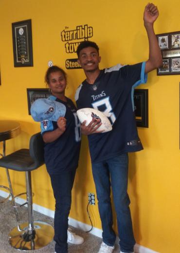 Jason and his mom wearing Titans jerseys