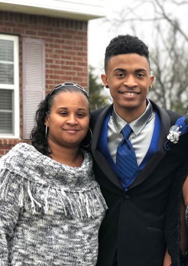 Jason wearing a suit next to his mom