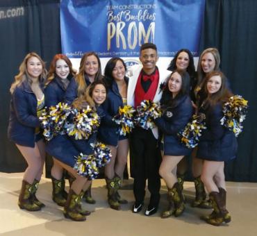 Jason with a group of cheerleaders at prom