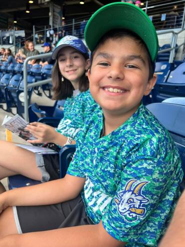 Jeffrey and his sister at a baseball game