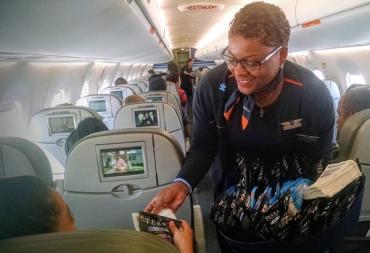 Jet Blue stewardess wearing an Autism Speaks pin while passing out snacks on a flight