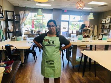 Kaitlyn wearing an apron while working at AR Workshop