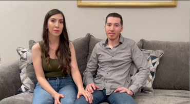 Parents of Mariano sitting on grey couch