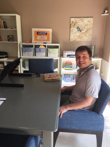 Lisa's son John sitting at a desk