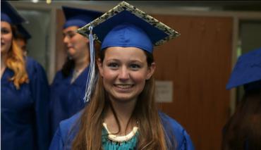 Madison wearing her cap and gown at graduation