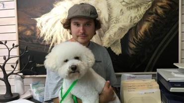 Nils holding a white dog