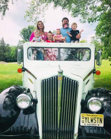 Nolan and his family in an old fashion truck