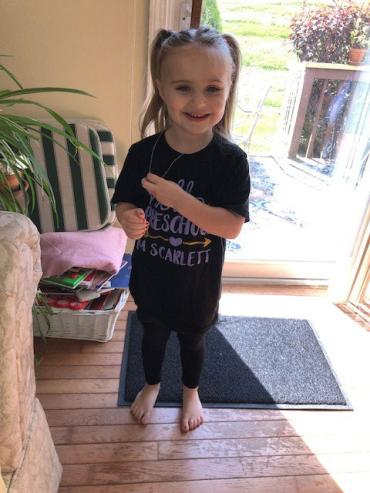 Scarlett wearing a black shirt for her first day of preschool