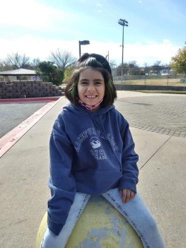 Sofia smiling and wearing a blue hoodie