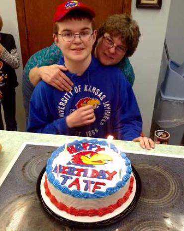 Tate and his mother Lisa in front of his birthday cake