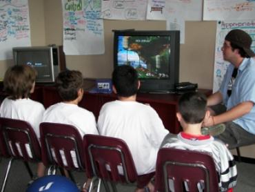 Teens in a classroom watching an educational show