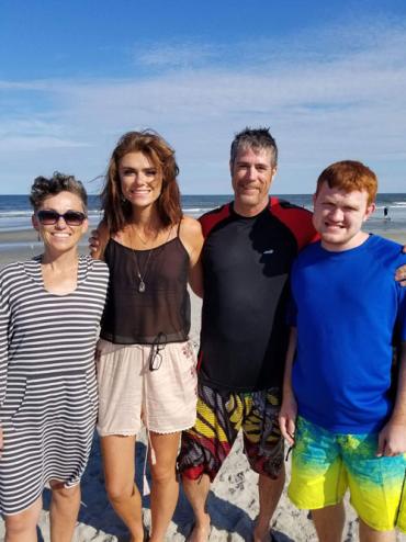 Tom and his family at the beach