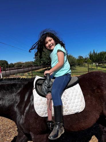 Valeria riding a horse