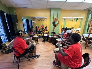 Victoria and friends practicing West African drumming