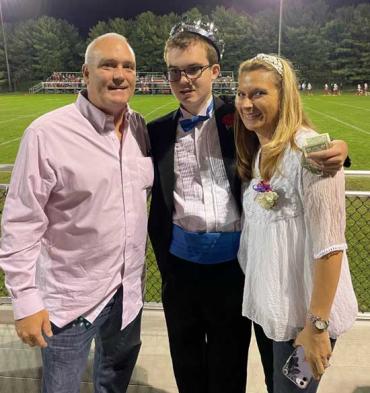 Warren and his parents after he was crowned Homecoming King