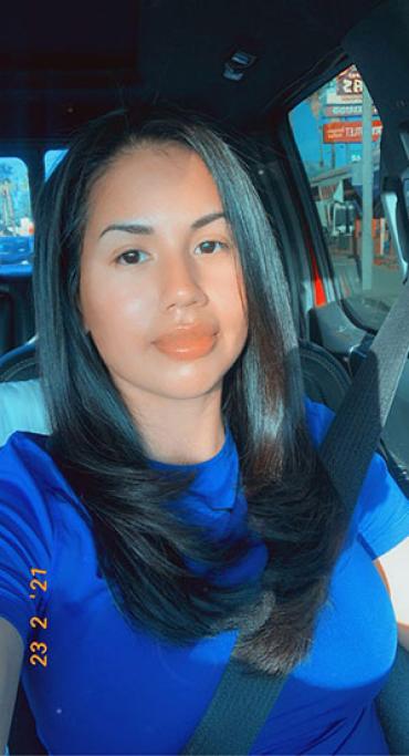 Yadira wearing a blue shirt in the car