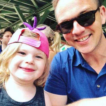 a father with his little girl wearing a pink hat