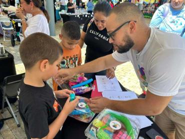 a man in glasses talking to children