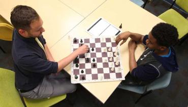 aerial view of two men playing chess