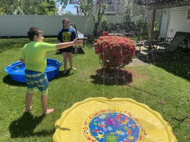 children playing with water toys outside