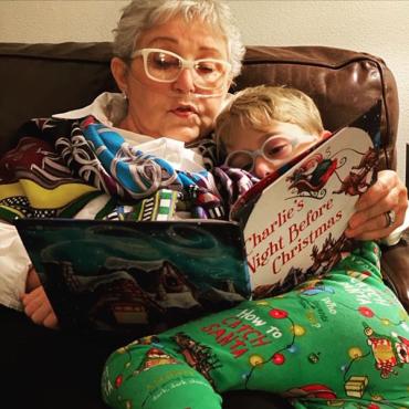 grandmother reading her grandchild a Christmas book