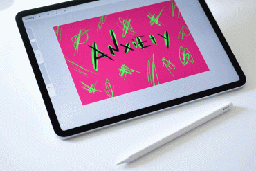 iPad with the paint app open to a design that says 'anxiety'