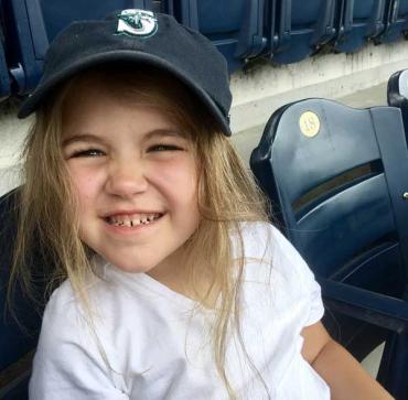 little girl wearing a baseball hat