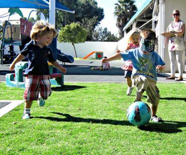 preschool students playing soccer