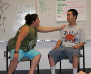 teen students sitting in the front of a classroom