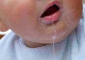 close up of a baby drooling